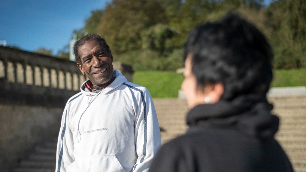 Two older people outside socialising