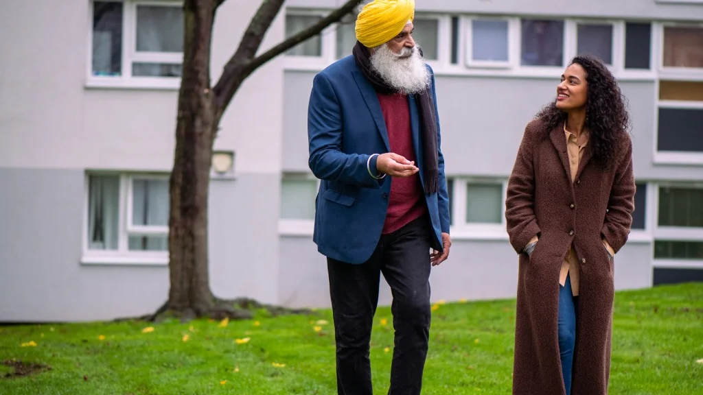 An older man and younger woman walking