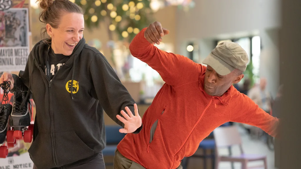 Two older people rollerskating