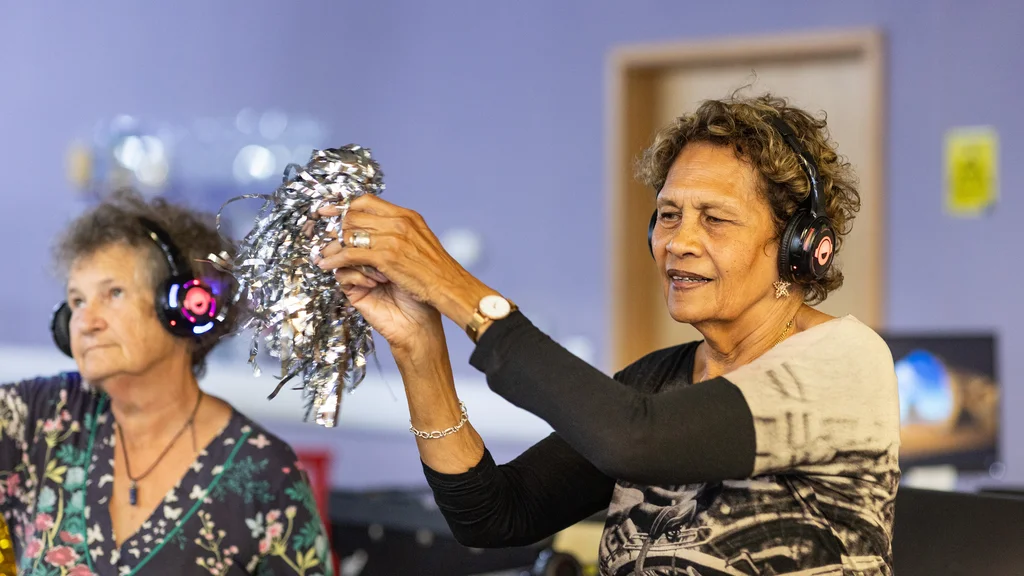 Older woman dancing at a silent disco